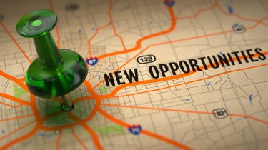 New Opportunities – Green Pushpin on a Map Background.